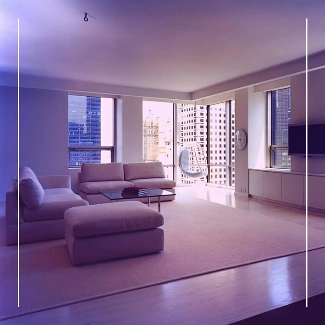 Minimal high-rise living room with a sectional sofa and corner city views