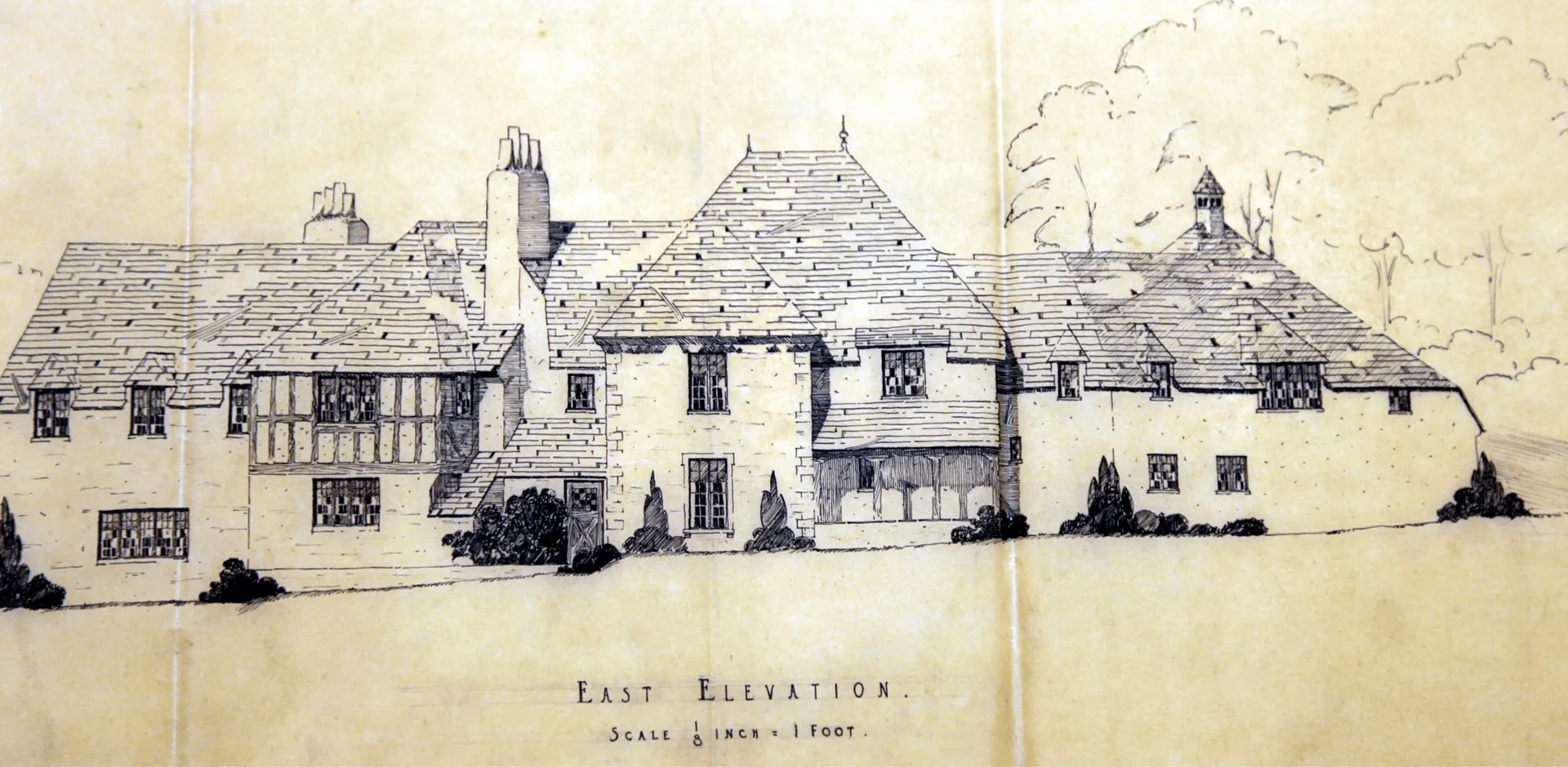Hand-drawn east elevation of a Tudor-style manor house with steep slate roofs