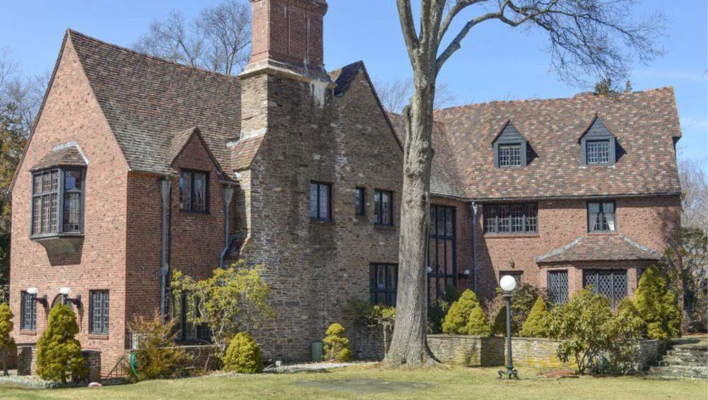 Tudor Revival house of brick and fieldstone with steep gabled roofs